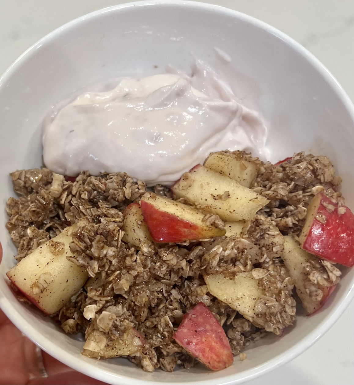 yogurt, oats, and apples combined in a bowl